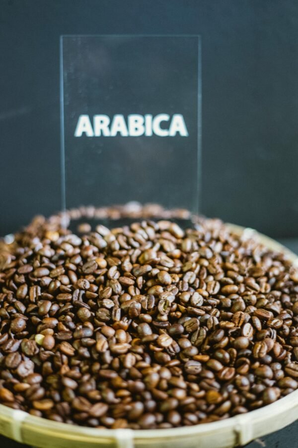 High-quality roasted Arabica coffee beans in a basket, perfect for coffee lovers.